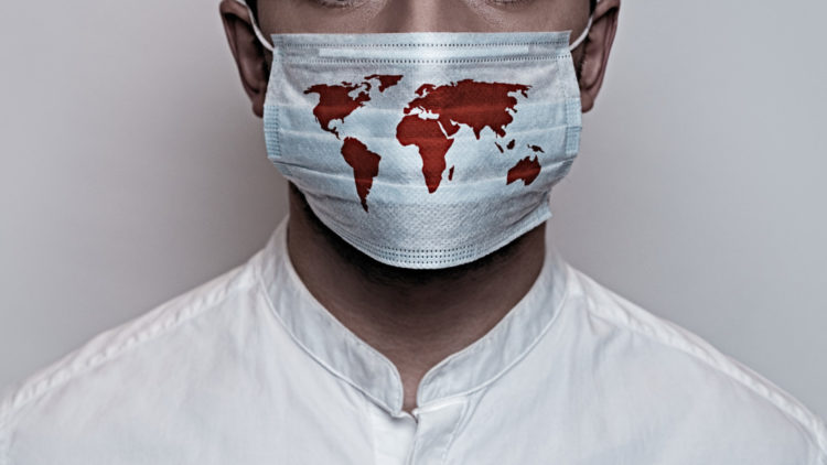 Концепция карантина коронавируса, Covid-19. Мужское лицо закрыто защитной медицинской маской с картой мира